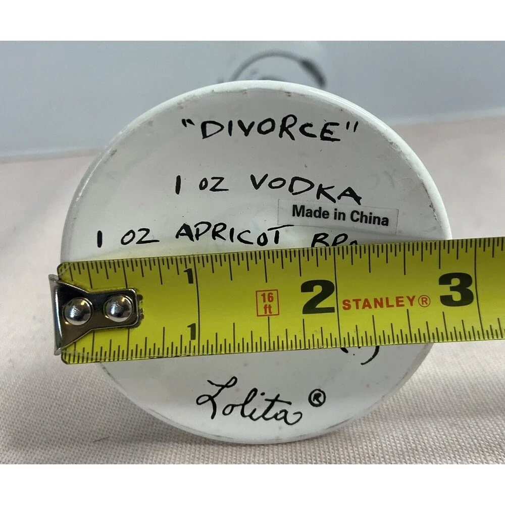 LOLITA - DIVORCE CHAMPAGNE FLUTE GLASS HAND PAINTED. SOME PAINT WEAR ON GLASS.